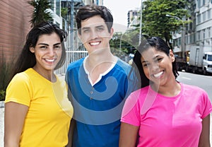 Group of laughing latin american and caucasian women and man