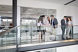 Group of lawyers discussing contract together in office