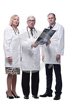 group of leading medical specialists looking at an x-ray.