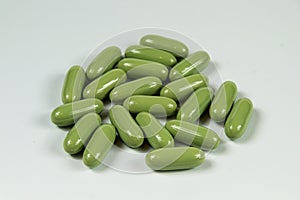 Group of light green soft gelatine capsules.