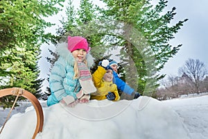 Group of little children play snowball in fortress