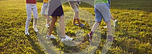 Group of little children playing in the park, dancing round dance and having fun