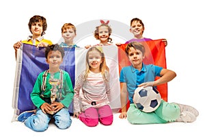 Group of little football fans holding French flag