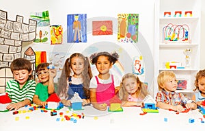 Group of little kids friends play with blocks