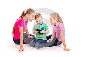 Group of little kids looking into tablet pc