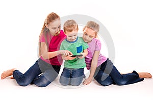 Group of little kids looking into tablet pc