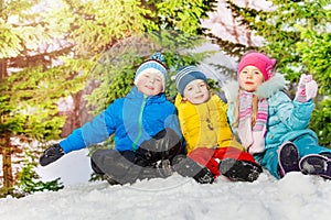 Group of little kids in the snow park at winter