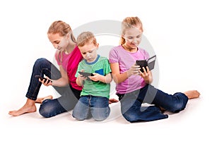 Group of little kids using electronic devices