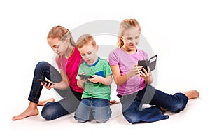 Group of little kids using electronic devices
