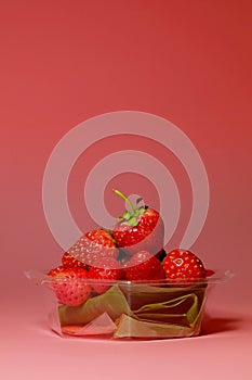 Group of little lovely sweet strawberry with pink background.