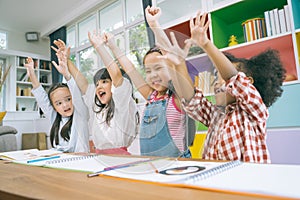 Group of little preschool kids hands up in class . portrait of children diversity education concept.