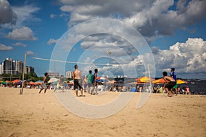 Local Brazilians playing beach volleyball in the Ponta Negra beach in Manaus, the Amazon, Brazil, South America