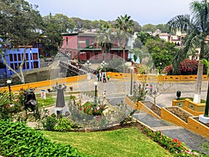 A group of local Peruvians and tourists enjoying the parks and art displays outside around the Plaza Chabuca Granda