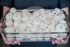 Group of lychee and peeled in glass tupperware