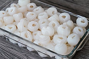 Group of lychee and peeled in glass tupperware