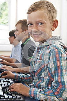 Group Of Male Elementary School Children In Computer Class