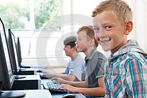 Group Of Male Elementary School Children In Computer Class