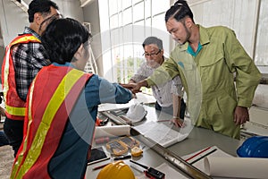 A group of male and female engineers are hand in hand in the con