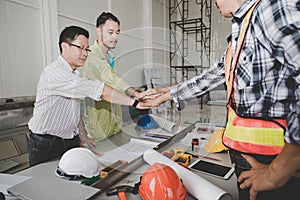 A group of male and female engineers are hand in hand in the con