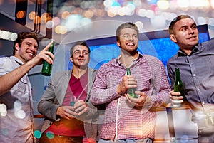 Group of male friends with beer in nightclub