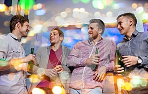 Group of male friends with beer in nightclub