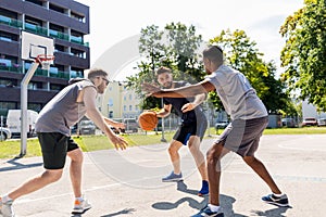 Group of male friends playing street basketball