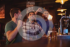 Group of male friends watching football match