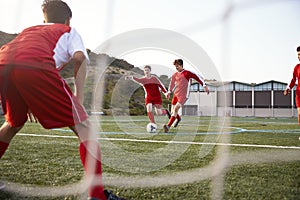 Group Of Male High School Students Playing In Soccer Team