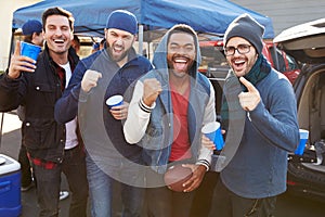 Group Of Male Sports Fans Tailgating In Stadium Car Park photo