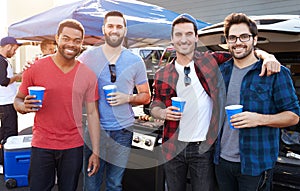 Group Of Male Sports Fans Tailgating In Stadium Car Park