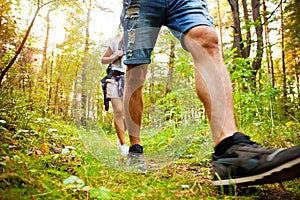 Group of man and women during hiking excursion in woods, walking while enjoying their journey