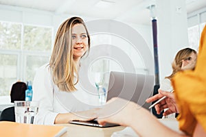 Group of managers sits around table at office and having a meeting on new project