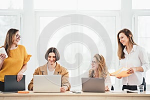 Group of managers sits around table at office and having a meeting on new project