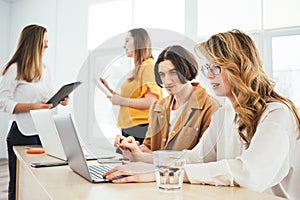 Group of managers sits around table at office and having a meeting on new project