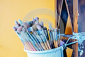 Group of many different old brushes, paints and brushes