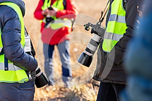 Group of many people watching planes landing and take off airport runway field planespotting conference warm morning