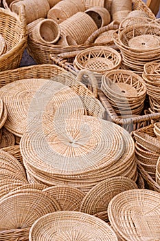 Group of many various handmade wicker trays and baskets for sale at Thailand street market