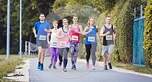 Group of marathon athletes running on street