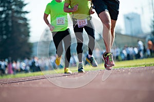 Group of marathon racers runningon the track