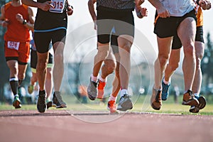 Group of marathon racers runningon the track