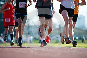 Group of marathon racers runningon the track