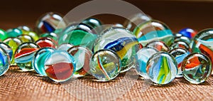 Group of marbles on a textured dark brown cloth