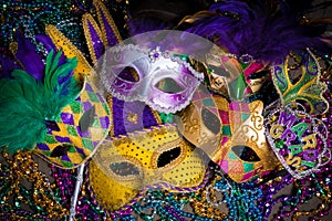 Group of Mardi Gras Mask on dark background with beads