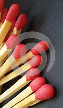 A group of matchsticks over black background.