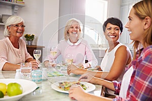 Group Of Mature Female Friends Enjoying Meal At Home