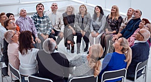 a group of mature mature people stretched their arms forward sit
