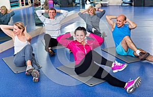 Group of mature people exercising on sport mats