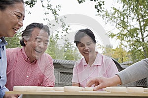 Group of mature people playing Chinese checkers