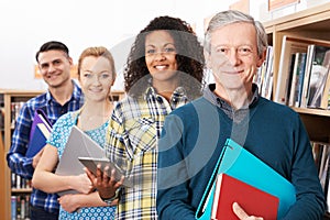 Group Of Mature Students Studying In Library