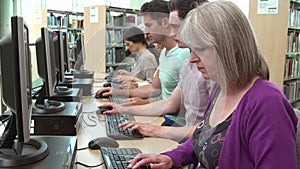 Group Of Mature Students Working At Computers